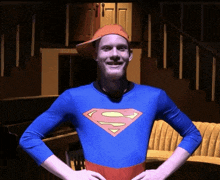 a man wearing a superman costume and a hat