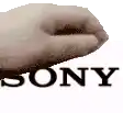 a close up of a person 's hand with the sony logo behind it .