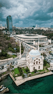 an aerial view of a city with a stadium and a mosque