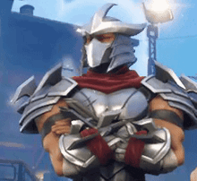 a man in armor and a mask is standing with his arms crossed in front of a building .