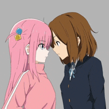 a pink haired girl and a brown haired girl are facing each other and looking at each other