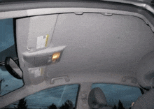 the roof of a car with a sun visor and a rear view mirror