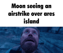 a man with a beard looking up at the moon