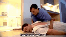 a man is laying on the floor and a nurse says this floor is my friend .