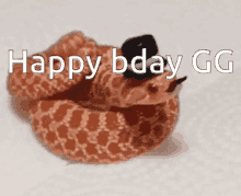 a snake wearing a top hat with the words happy bday gg on it