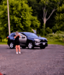 a blurry photo of a woman standing in front of a car with the name crypt keeper karen on the bottom