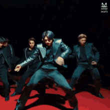 a man in a suit is dancing on a red carpet with jkgifs written on the bottom right