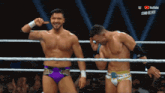 two wrestlers are standing in a wrestling ring with a youtube logo in the corner