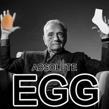 a man is holding an egg and a sock in his hands with the words absolute egg below him