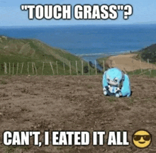 a stuffed animal is sitting on top of a dirt field with a fence in the background .