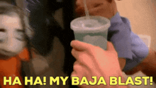 a person holding a cup with a straw and the words " ha ha my baja blast " in yellow