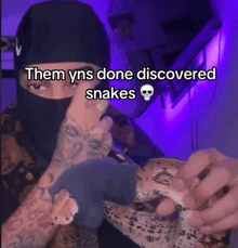 a man holding a snake with the caption " them yns done discovered snakes " on the bottom