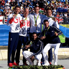 a group of men are posing for a picture and one of them is wearing a sweatshirt that says u.k