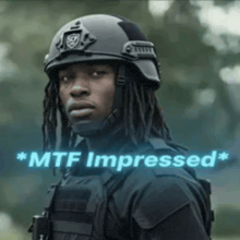 a man wearing a helmet and a vest with the words `` mtf impressed '' written on it .