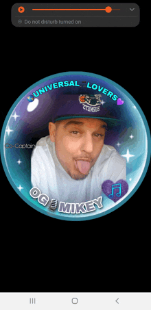 a man wearing a hat that says universal lovers sticking out his tongue