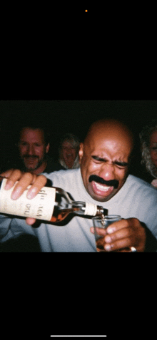 a man with a fake mustache pouring a bottle of glenlivet into a glass