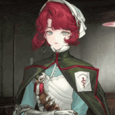 a girl with red hair is wearing a green cape with a pocket that says " st. philip hospital " on it