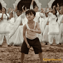 a boy in a white tank top stands in front of a group of women with x @ iamhemuk written on the bottom