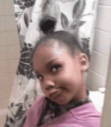 a girl taking a selfie in a bathroom with a shower curtain behind her