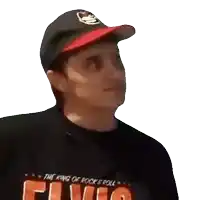 a man wearing a hat and a shirt that says flying