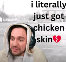 a man wearing headphones says i literally just got chicken skin with a broken heart in the corner