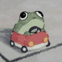 a frog is driving a red car on a road .