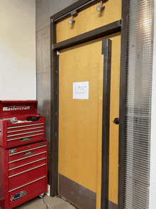 a mastercraft toolbox sits in front of a door