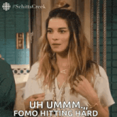a woman is standing in front of a door and says uh ummm .