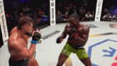 two fighters are fighting in a ring with a sign that says arkham