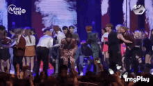 a group of people are dancing on a stage with a watermark that says imgplay on it