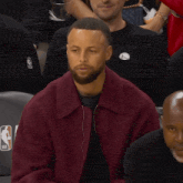 a man with a beard wearing a purple jacket
