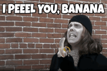 a person holding a banana in front of a brick wall with the words i peel you banana