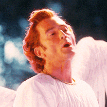 a man with red hair is dressed as an angel with wings