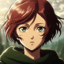 a girl with red hair and green eyes looks at the camera