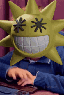 a person wearing a yellow star mask with black stars on it