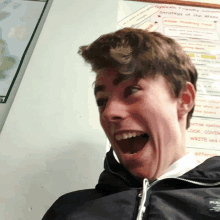 a young man is making a funny face in front of a board that says spelling