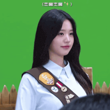 a girl wearing a scout uniform with a brown sash
