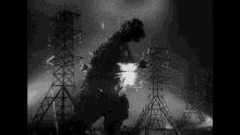 a black and white photo of a monster standing in front of power lines