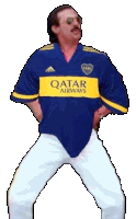 a man wearing a blue qatar airways shirt is dancing