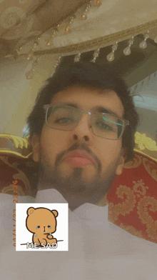 a man wearing glasses has a sticker of a teddy bear that says mesad on it