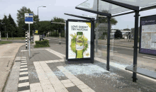 a bus stop with a sign that says " love green try matcha "