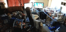 a messy room with two computer monitors and a box that says box