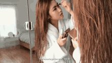 a woman applying makeup in front of a mirror with the words " so i have to go live on t today "