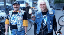 two men are standing next to each other with one wearing a black shirt that says ' freedom '