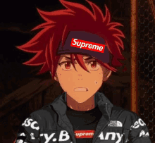 a boy with red hair is wearing a supreme hat