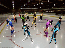 a group of people are dancing on a ice rink with the website lulinternet.com visible in the corner