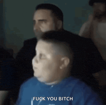 a man is giving a boy a haircut and the boy is saying fuck you bitch .