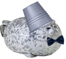 a stuffed seal wearing a bow tie and bucket on its head