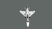 a fighter jet with vw on the tail is flying in the air