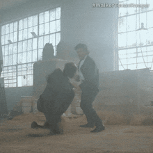 two men are fighting in a room with the hashtag #walker texasranger